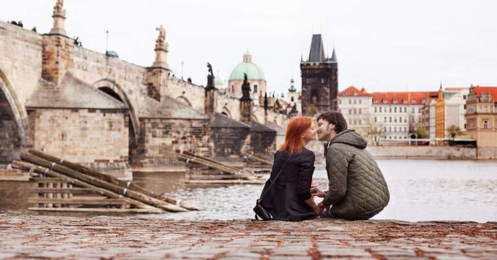 Prague couple kissing on river