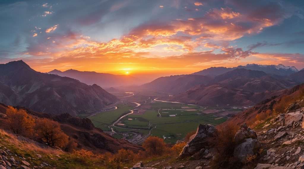 A scenic view of a Pakistani landscape at sunset, featuring a vibrant sky with orange and pink hues. Mountains and lush green fields surround a winding river below.