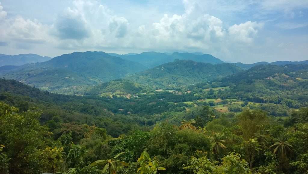 Green hills and a distant mountain range in Nigeria.