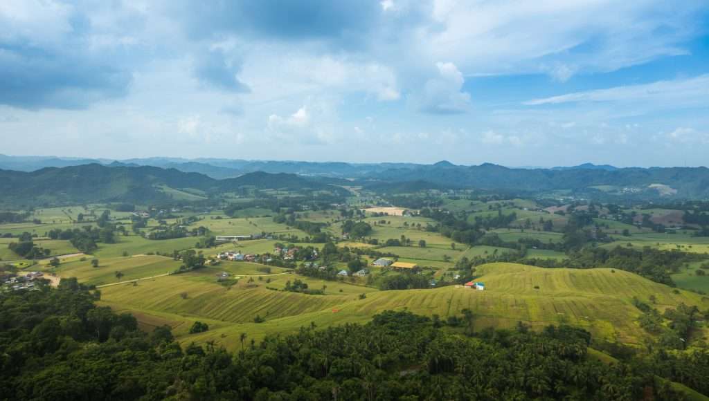 Rolling green hills and patchwork fields in the Philippines.