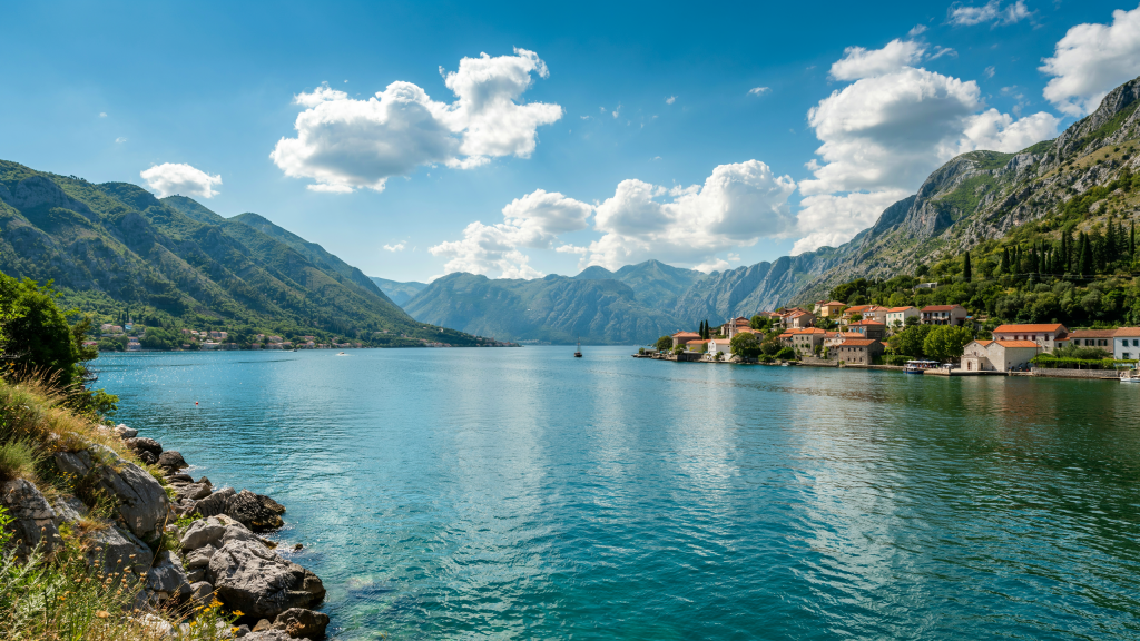 A calm bay with mountains and a small coastal village in Montenegro.