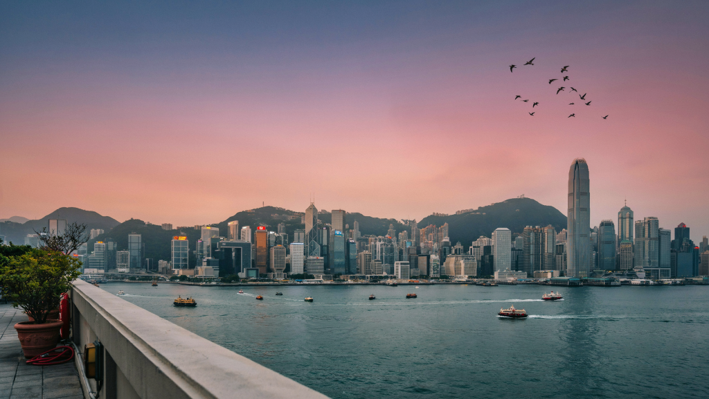 Hong Kong skyline across the harbor at sunset.