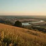 A winding river through fields and hills in Belarus.