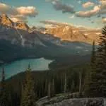 A turquoise lake below forested mountains in Canada.